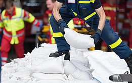 The fire brigade builds a wall of sandbags.